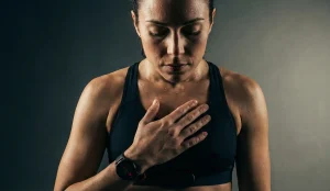 woman concentrating on heartbeat in athletic bralette