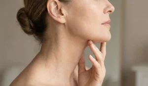 woman touching jawline neck profile
